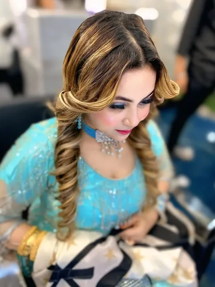 Another angle of the soft glam hairstyle, showing how the curls are structured to create a flattering shape. This is a versatile look for any member of the bridal party.