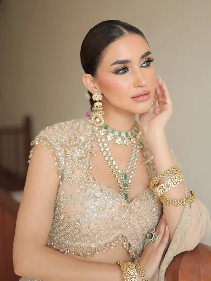 This shot captures the delicate handiwork on the blouse and the elegant fall of the lehenga skirt, a testament to understated luxury.