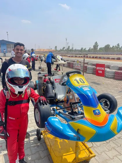 A duplicate shot of a young driver with his mechanic.