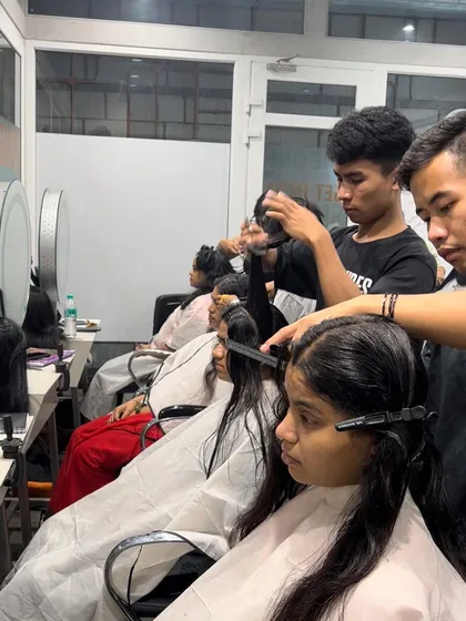 Our hair students get valuable hands-on experience working on real models during a busy haircutting session.