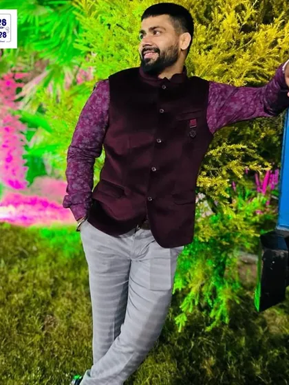 This client chose a rich purple velvet Nehru jacket paired with a patterned shirt for an evening function. We ensure the fit is comfortable yet structured, perfect for celebrating in style.