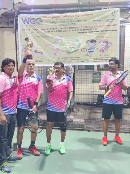 The victorious Men's Doubles team celebrating their championship win at the WCG Women's Day Festival.