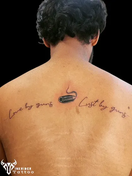 This was a unique cover-up project. We incorporated a small bullet design and script to rework and hide a previous tattoo on the client's back.