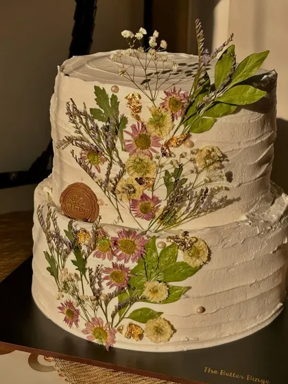 Your special moments deserve a one-of-a-kind centerpiece. This two-tier Belgian chocolate engagement cake was decorated with beautiful, hand-pressed dried flowers for a rustic and romantic 'Into The Wild' theme.