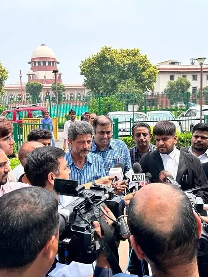 Surrounded by media after a crucial hearing at the Supreme Court. High-profile cases often require clear communication to the public about the legal proceedings and their implications.