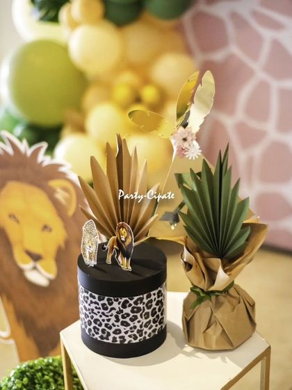 Themed decorative boxes with animal prints and papercraft details added another layer of customization to this beautiful safari setup.