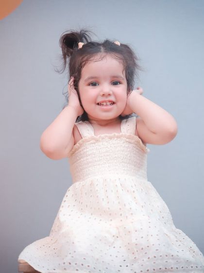 A slightly different take on this adorable two-year-old's portrait, showing her sweet smile.