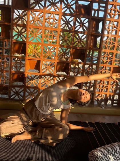 A gentle side bend in a restorative practice. The focus here is not on how deep you can go, but on the sensation of release and the connection to your breath.