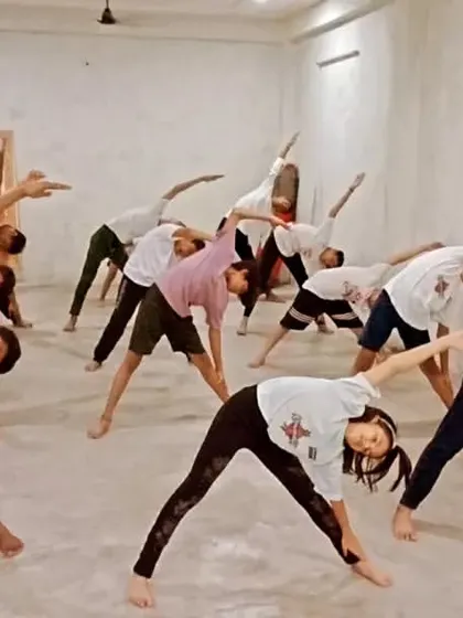 The class practicing a side-bending stretch. This helps to open up the hips and improve the range of motion for kicks.