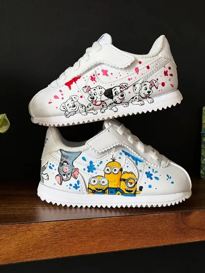 The perfect gift for the little ones in your life. These kids' Nikes feature two different themes: 101 Dalmatians on one shoe and the Minions on the other.