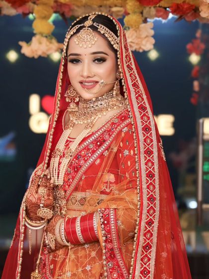 A full bridal look, complete with a radiant smile. The makeup is flawless and ready for the camera.
