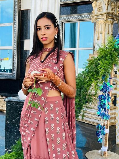 This shot captures the effortless elegance of the look, from the sleek hair to the glowing makeup and modern attire.