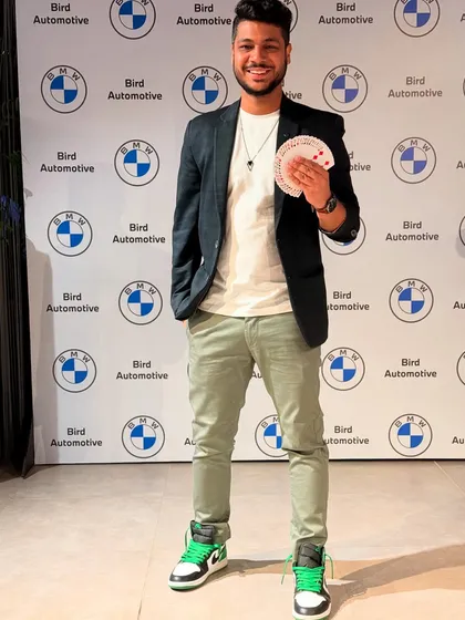 Posing with a fan of cards at a BMW Bird Automotive event. My magic is a perfect addition to car launches and showroom events, adding a layer of excitement and wonder.