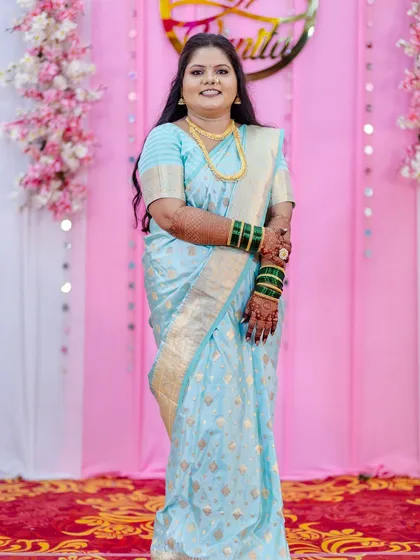 A duplicate of image 2, this full-length photo showcases the complete look. The professional saree draping and cohesive makeup and hair styling create a polished and elegant appearance.