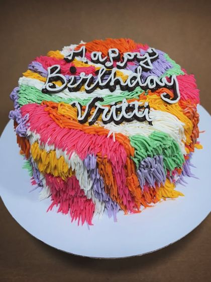 Whimsical cakes are so much fun. This shaggy-style cake with a rainbow of colors is a playful and unique design for a vibrant birthday celebration.