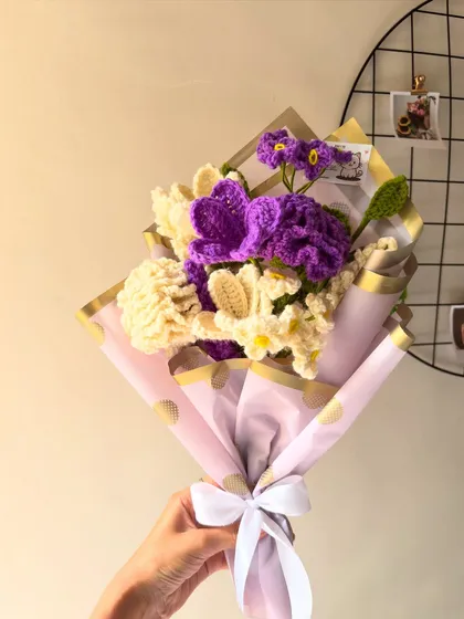 A custom bouquet with purple and white flowers, wrapped in pretty pink paper for a soft and elegant look.