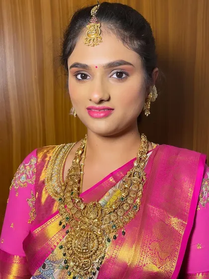 A close-up portrait that highlights the clean, defined eye makeup and the smooth, radiant finish of the skin.