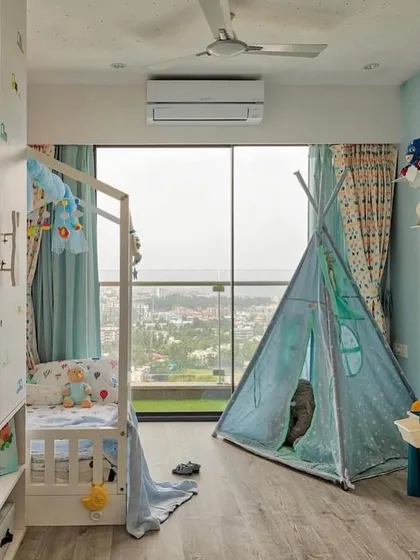 Designing for the little ones is always a joy. This child's bedroom combines a playful spirit with practical design, featuring a house-frame bed, a fun teepee for imaginative play, and plenty of natural light from the large window.