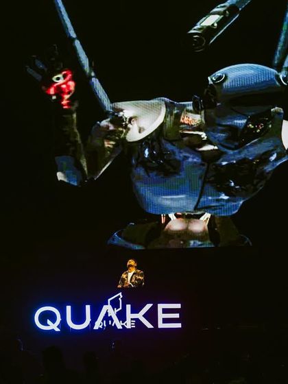 A giant robotic visual towering over me on the screen at Quake during the Bollywood Mansion event.