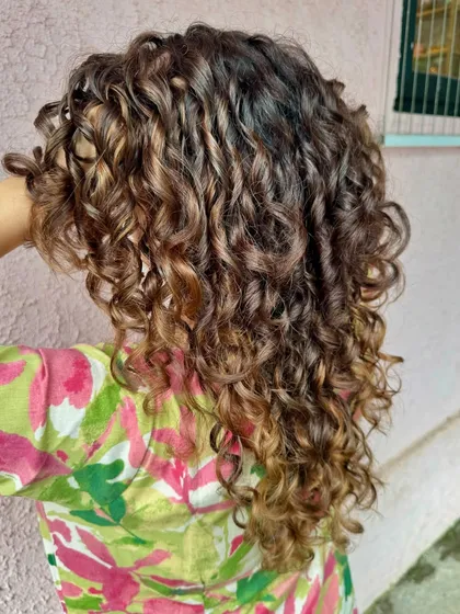 A 'Chocolate Swirl' transformation for these gorgeous curls. We did a fresh cut and added non-bleach color to define the ringlets and add richness.