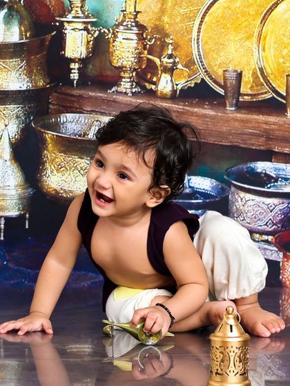 A joyful moment of discovery. This little one is crawling with his magic lamp, his happy expression lighting up the entire scene.