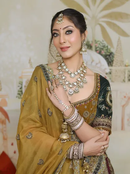 A full view of the bride, her makeup and jewelry creating a cohesive and regal look.
