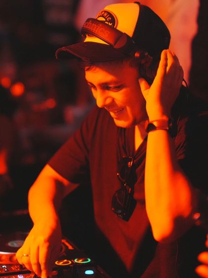 A close-up, red-lit shot of me smiling while I mix. This is pure passion.
