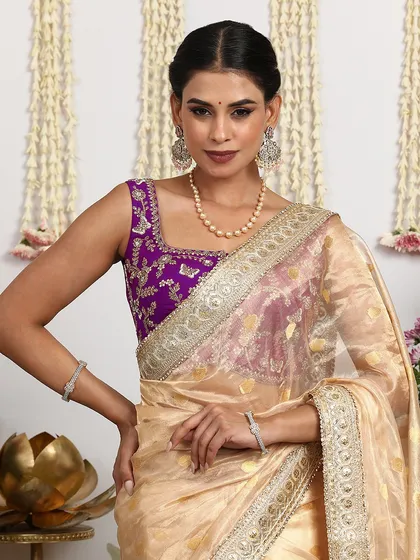 A close-up of the sleeveless purple blouse, showing the intricate embroidery and the beautiful fit.