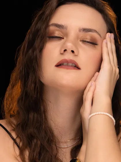 A serene portrait with the model's eyes closed, conveying a sense of peace and calm.