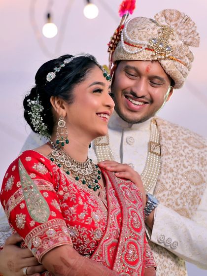 A joyful, candid moment between the bride and groom. Her bright smile and his affectionate gaze create a warm and happy wedding portrait.