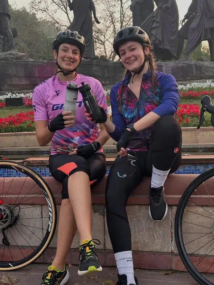 Two friends enjoying a post-ride chat and hydration break.