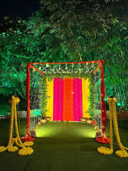 A vibrant and colorful entrance tunnel we created for a Diwali party, using bright fabric drapes and fairy lights to create a festive glow.