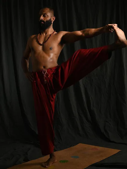 Utthita Hasta Padangusthasana B, the extended hand-to-big-toe pose with the leg opened to the side. This variation deeply opens the hips and inner thighs while challenging balance and concentration.