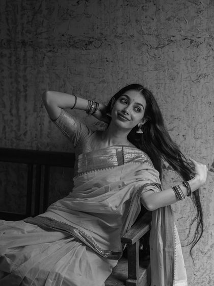 A black and white portrait exploring a moment of quiet femininity. The soft smile and pose are meant to feel gentle and introspective, showing a different, more subtle side of my expressive range.