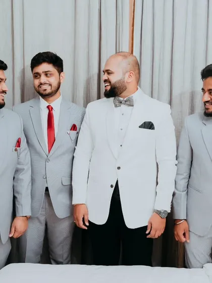 The groom and his groomsmen, sharing a moment of camaraderie before the ceremony begins. We believe the groom's story is just as important, and we capture these moments of friendship and support with a relaxed, candid style.