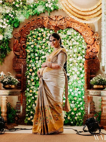 A full-length shot of me against the beautiful floral backdrop of my baby shower.