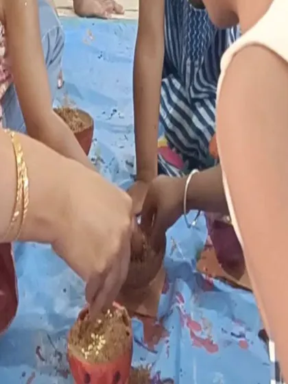 Children add the finishing touches to their painted coconut shells, a unique and eco-friendly craft idea.