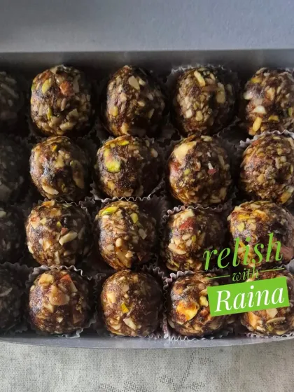 A box of my Dry Fruit Laddoos, showing the dark, rich color from the black dates I use as a natural sweetener.