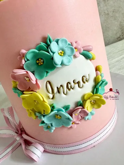 A detailed shot of the floral name plaque, with each tiny flower carefully placed.