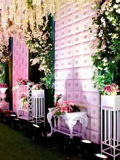 Another angle of the dreamy entrance, with textured walls and floral arrangements creating a layered and sophisticated look.