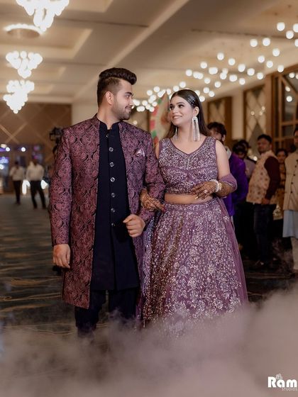 The couple makes a grand entrance through a cloud of smoke, adding a touch of drama and magic to their engagement party.
