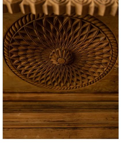 The intricate geometric carving on a repurposed wooden panel. This level of detail and craftsmanship is a hallmark of the vintage pieces we love to incorporate into our designs.