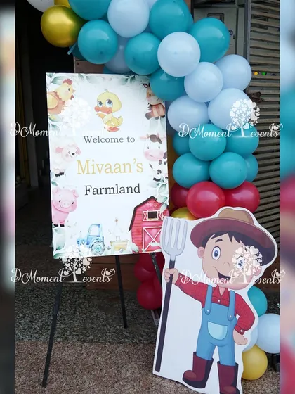 A charming welcome sign for "Mivaan's Farmland," complete with a little farmer cutout to greet the guests.