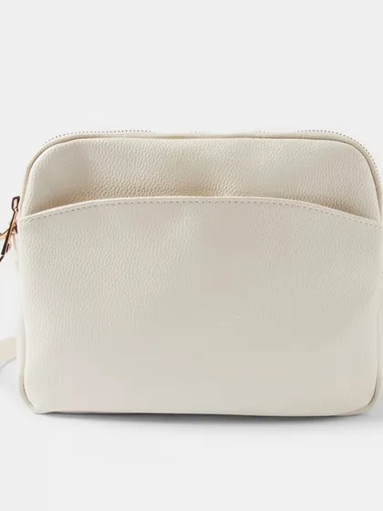 The Australia Crossbody bag in four versatile colours. This image shows the off-white, pink, olive green, and black options available.