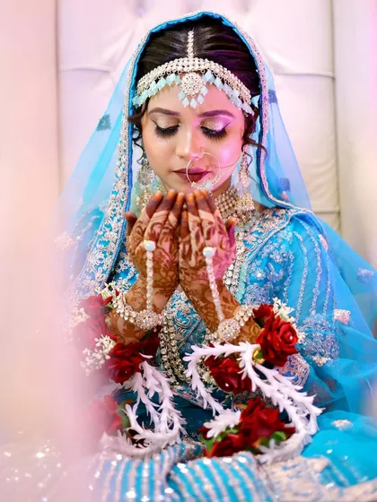 Another beautiful shot of the Nikkah bride in prayer. The soft lighting highlights the ethereal quality of her makeup.