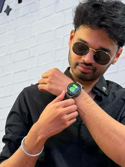 Showcasing the Samsung Galaxy Watch as part of a sleek, all-black outfit. This lifestyle shot positions the tech gadget as a fashion accessory.