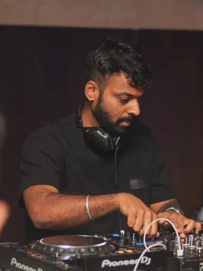 A shot of me working the mixer at a sundowner. The focus is on creating that perfect, epic vibe.