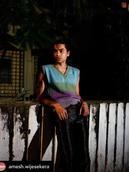 Another look from the Amesh Wijesekera editorial. The grooming is consistent and clean, ensuring the model looks polished and sharp under the dramatic nighttime lighting.