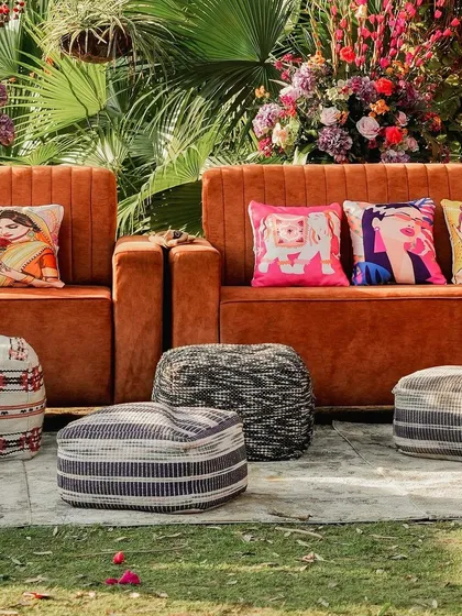 Comfort meets style in this outdoor Mehendi lounge. I used plush velvet sofas and a variety of quirky, printed cushions and poufs to create a relaxed and eclectic seating area for guests.