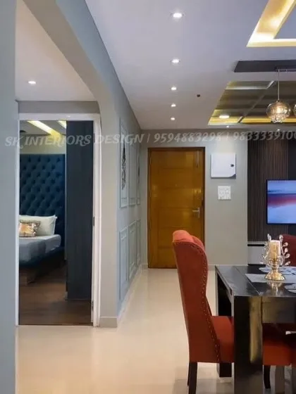 A view from the dining area down a corridor, showing a glimpse into a bedroom with a striking blue tufted headboard. This highlights the consistent design quality we maintain across every room of the house.